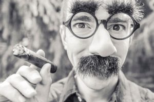 Man wearing fake glasses and moustache